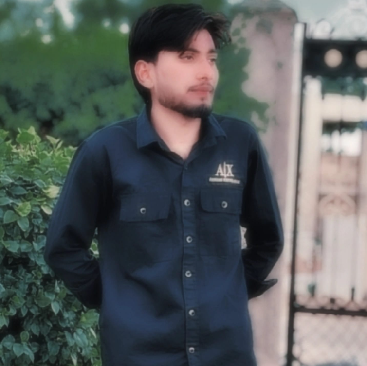 screenshot 2025 09 05 063404 This image features a person wearing a black shirt, standing outdoors. The background shows greenery and a gate or wall. The face of the person is blurred to maintain privacy. This photo can be used as a profile image or for social media/website purposes with hidden identity.